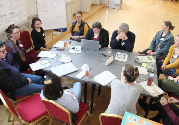 Participants sitting at a table, discussing