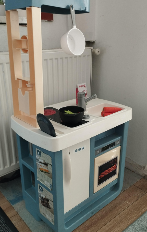 A play kitchen for children placed directly in front of a radiator.