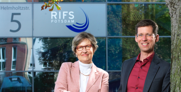 Doris Fuchs and Mark Lawrence standing in front of the mirrored facade of RIFS