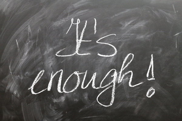 Text written on blackboard: "It's enough!"