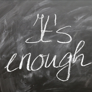 Text written on blackboard: "It's enough!"